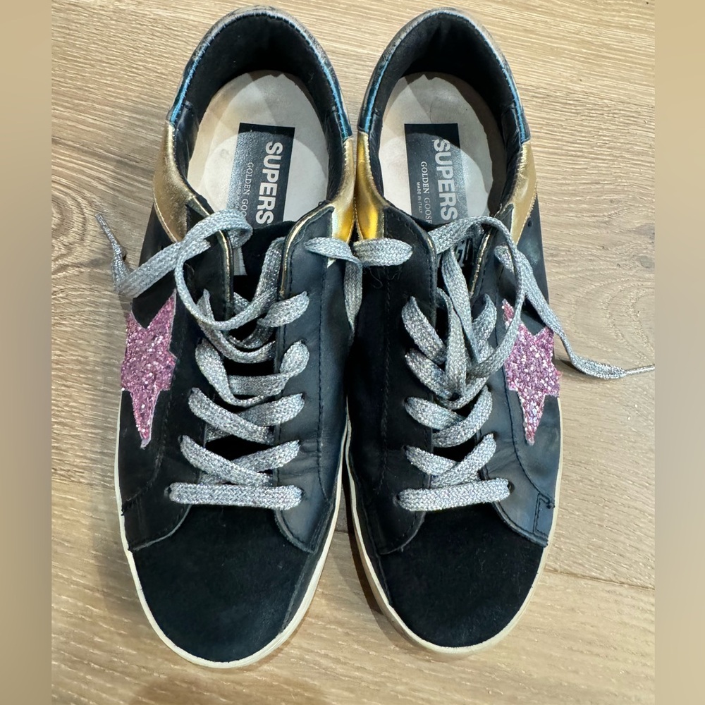 Golden goose low star black gold and pink sneakers.